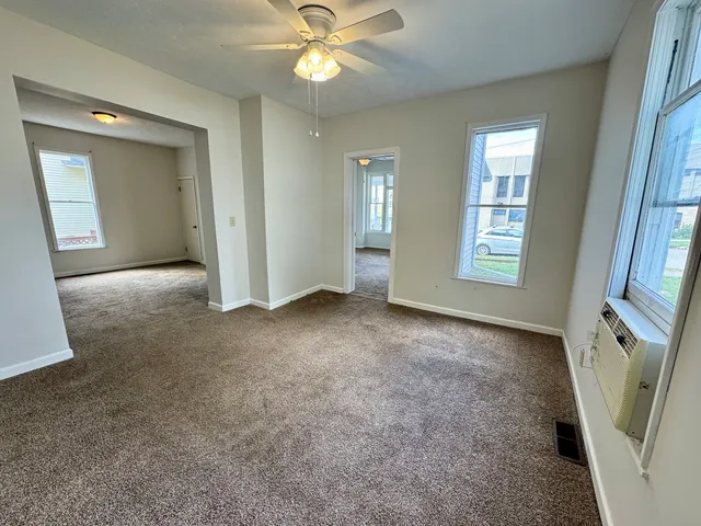 an empty room with windows and entrance