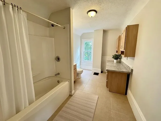 a view of a house with a yard and deck