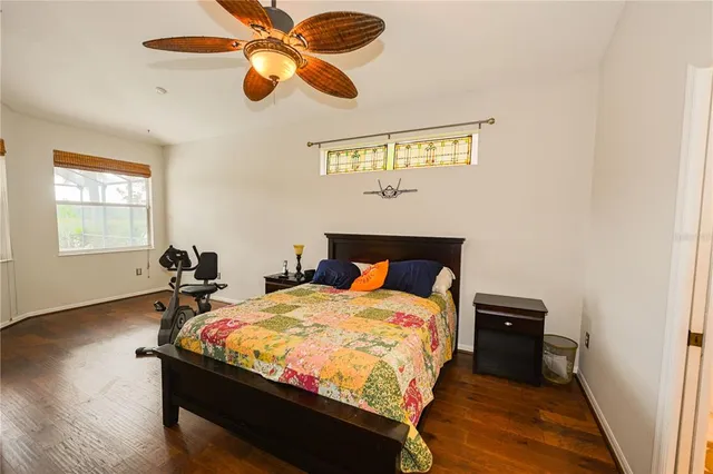 a bedroom with a large bed and a chandelier