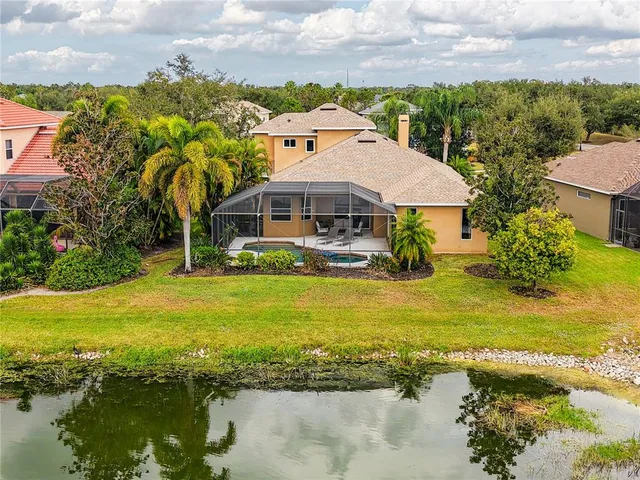 a kitchen with stainless steel appliances granite countertop a sink a stove top oven a granite counter space and cabinets