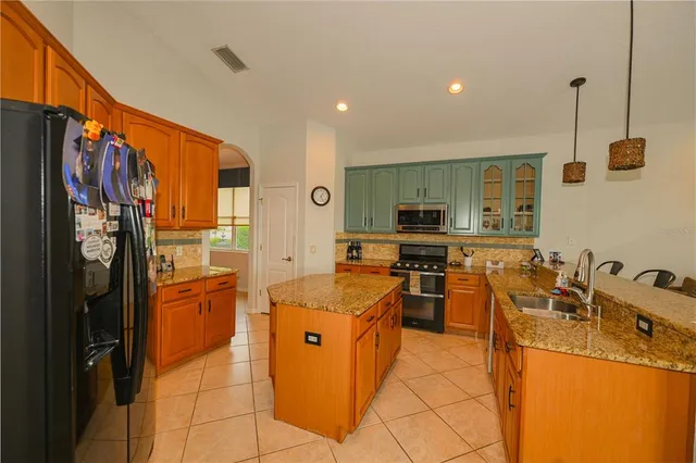 a living room with furniture kitchen view and a large window