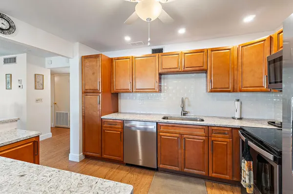 a dining room with furniture a chandelier and glass door