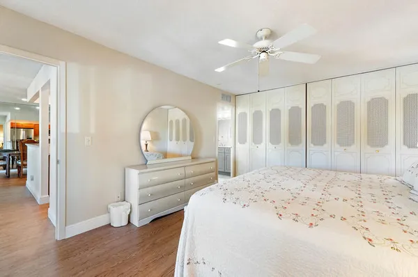 a spacious bedroom with a bed and a lamp