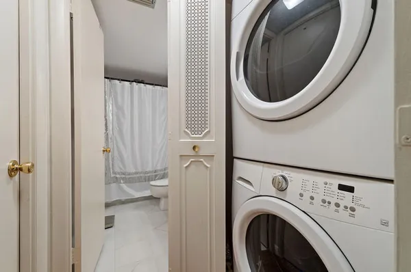 a bedroom with a bed mirror and a window