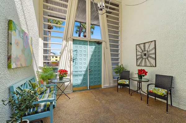 a view of a porch with furniture and garden