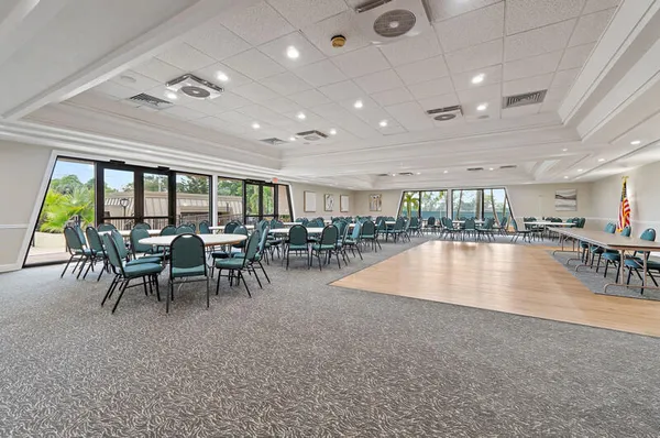 a kitchen with stainless steel appliances a sink a stove a microwave a refrigerator a white stove and cabinets