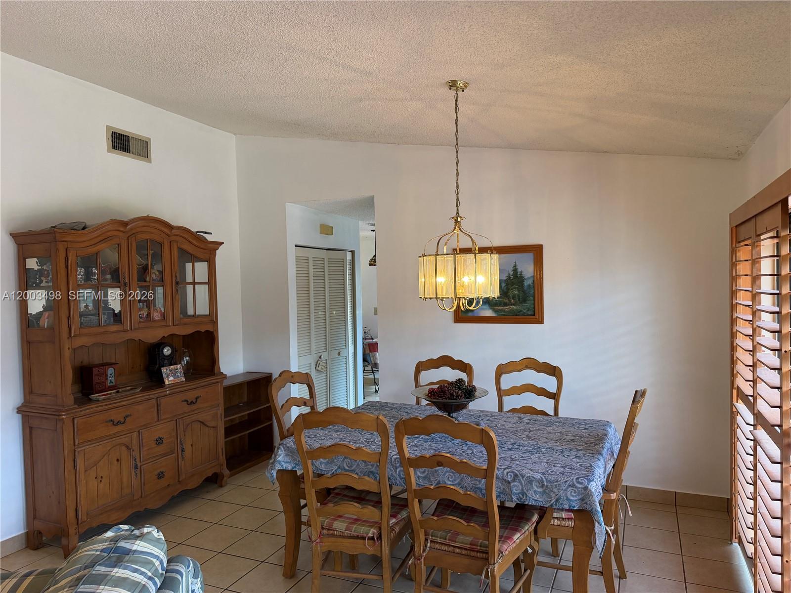 6010 Northwest 201st Lane Hialeah, FL 33015 - Photo 13 of 36 a dining room with furniture and window