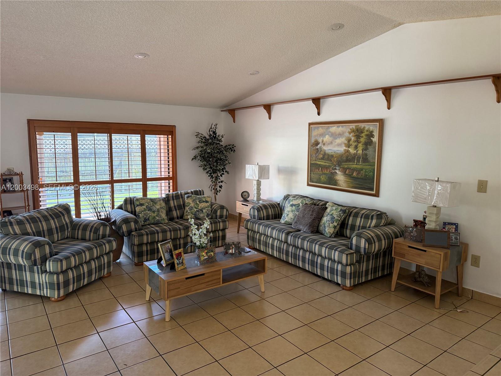 6010 Northwest 201st Lane Hialeah, FL 33015 - Photo 15 of 36 a living room with furniture and a large window