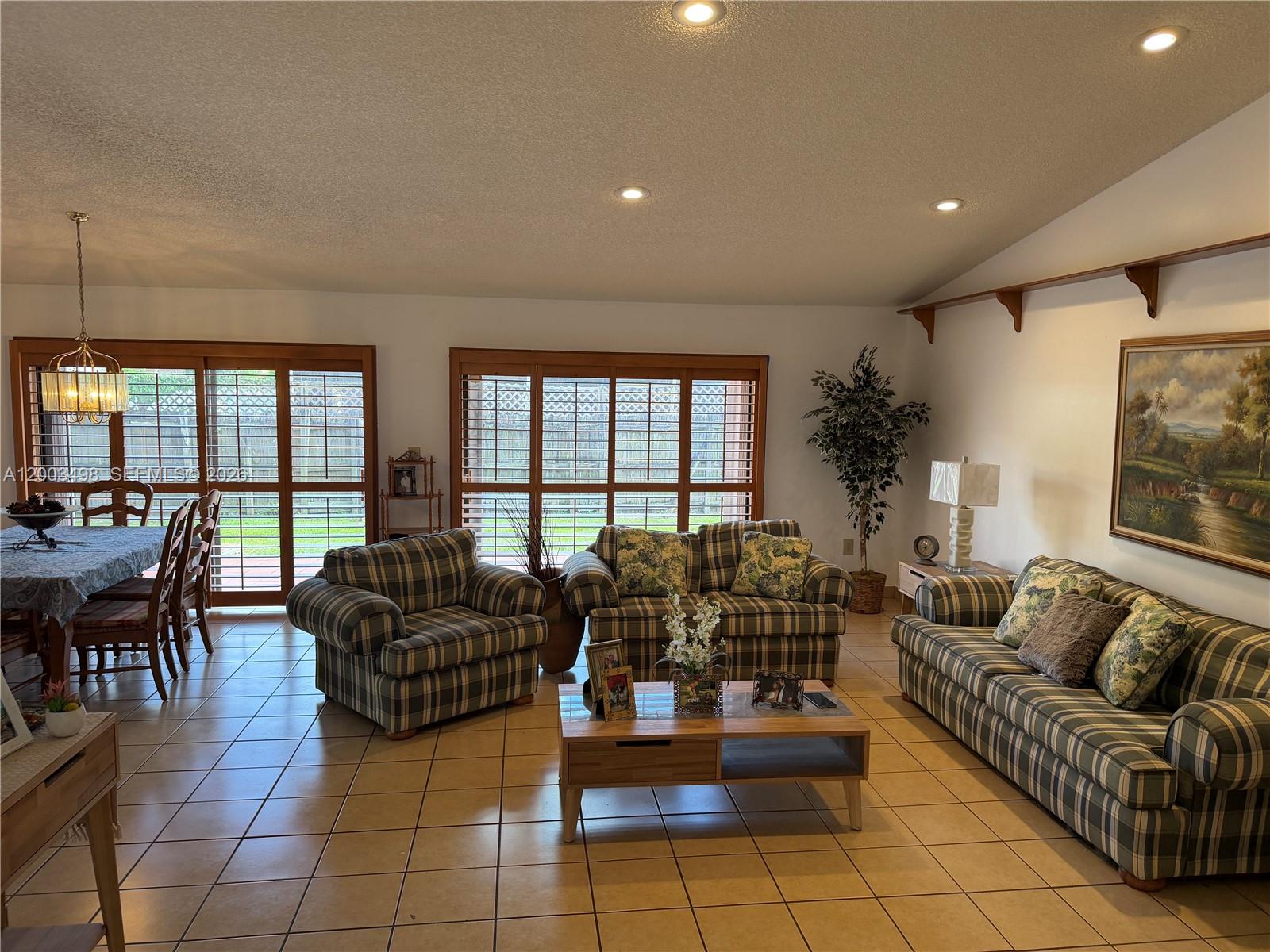 6010 Northwest 201st Lane Hialeah, FL 33015 - Photo 19 of 36 a living room with furniture and a large window