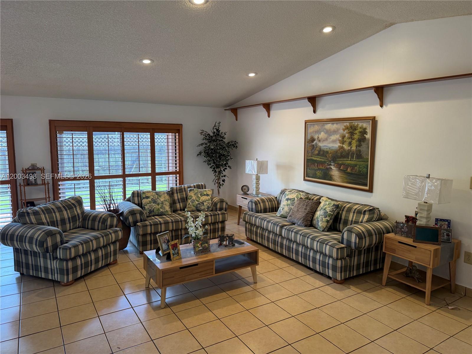 6010 Northwest 201st Lane Hialeah, FL 33015 - Photo 20 of 36 a living room with furniture and a large window