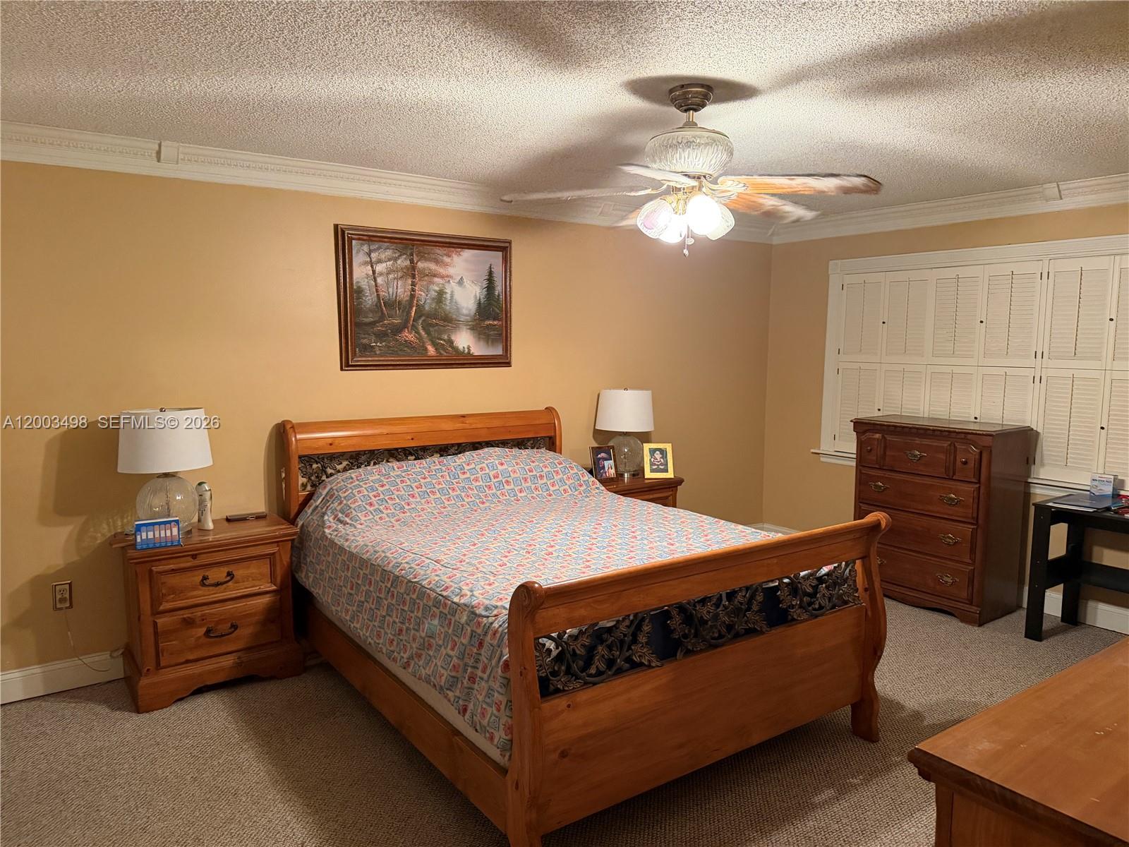 6010 Northwest 201st Lane Hialeah, FL 33015 - Photo 27 of 36 a bedroom with a bed and a chandelier