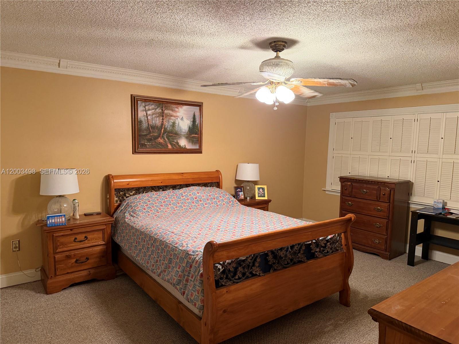 6010 Northwest 201st Lane Hialeah, FL 33015 - Photo 30 of 36 a bedroom with a bed and a chandelier