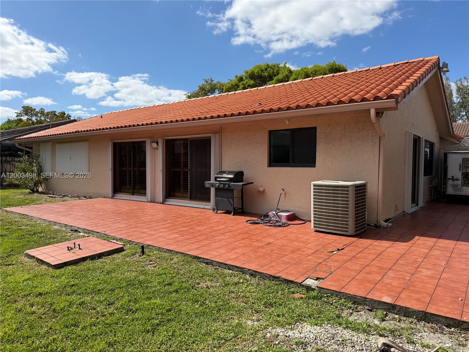 6010 Northwest 201st Lane Hialeah, FL 33015 - Photo 32 of 36 a view of a house with a yard and potted plants