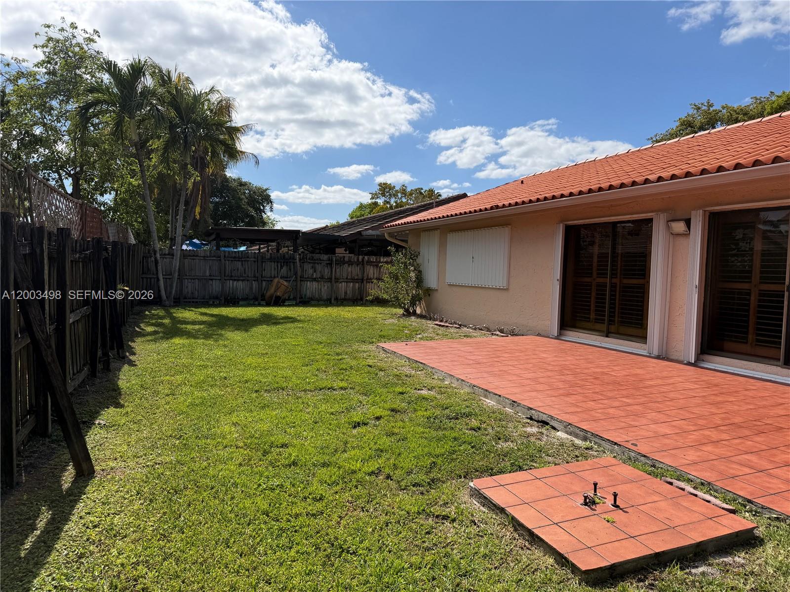6010 Northwest 201st Lane Hialeah, FL 33015 - Photo 33 of 36 a backyard of a house with table and chairs