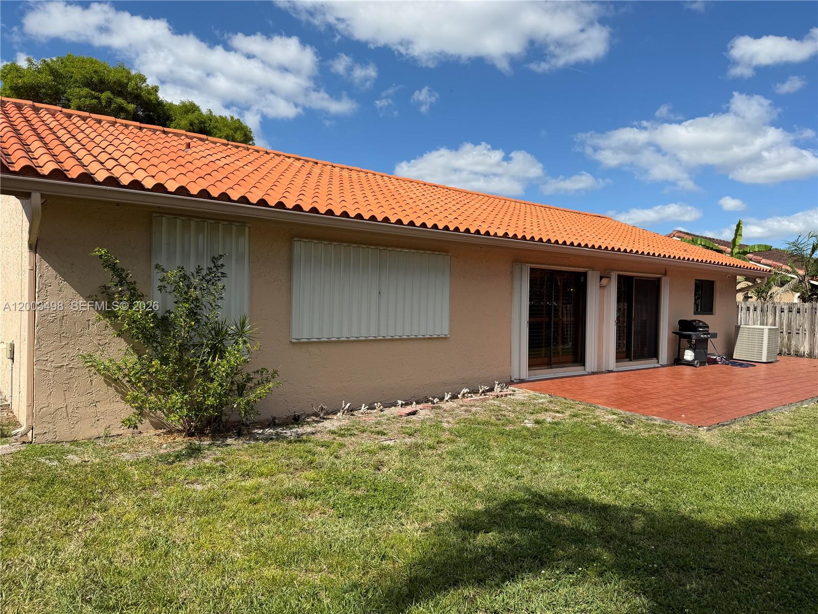 6010 Northwest 201st Lane Hialeah, FL 33015 - Photo 34 of 36 a front view of a house with a garden