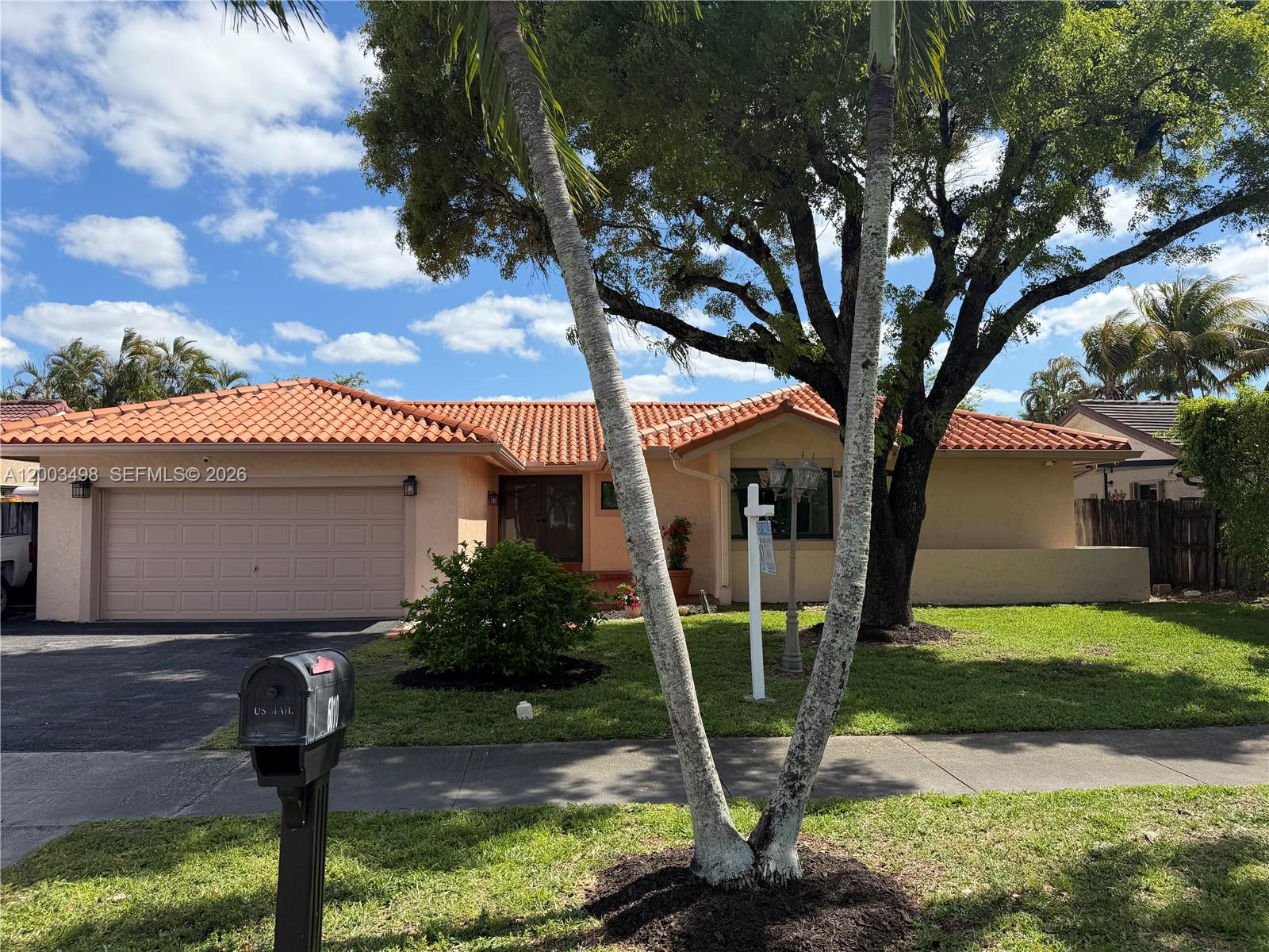 6010 Northwest 201st Lane Hialeah, FL 33015 - Photo 4 of 36 a front view of a house with garden