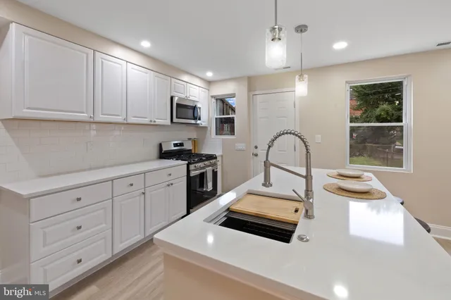 a kitchen with a sink appliances and cabinets