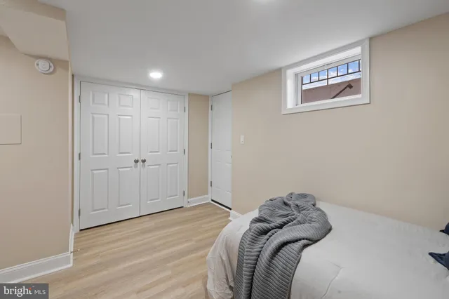 a bedroom with a bed and a painting on the wall