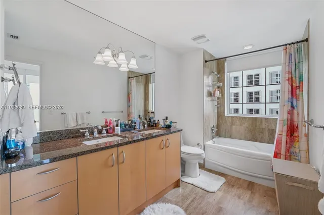 a bathroom with a double vanity sink and a bathtub