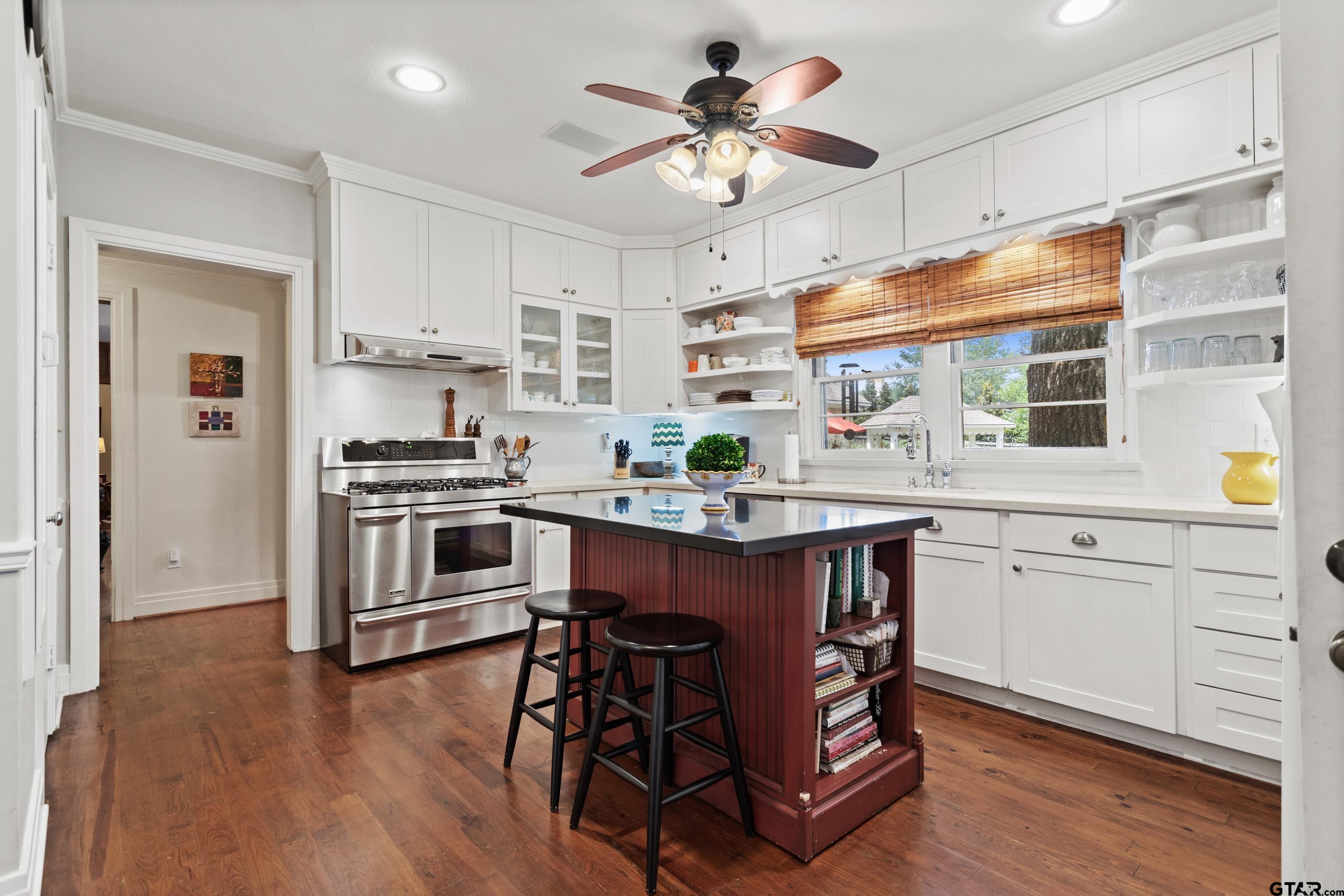 2631 Old Bullard Road Tyler, TX 75701 - Photo 26 of 43 a kitchen with wooden floors and appliances