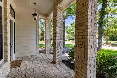 a view of a brick house with a potted plant