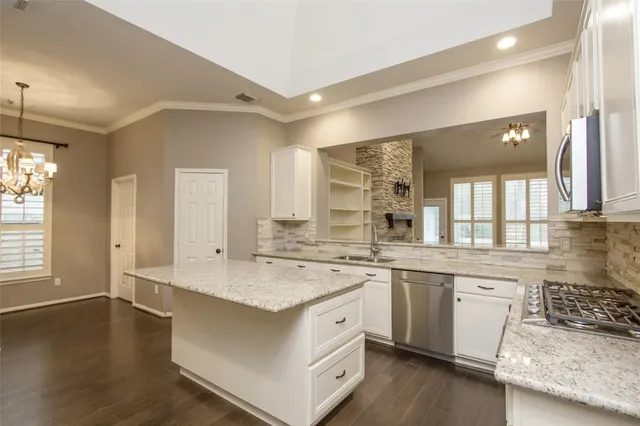 a kitchen with a sink stove and cabinets