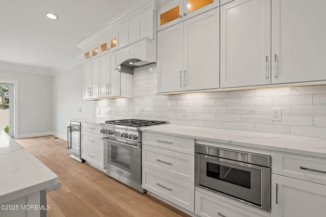 a kitchen with white cabinets and appliances