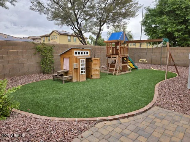 a view of a house with a backyard and a patio