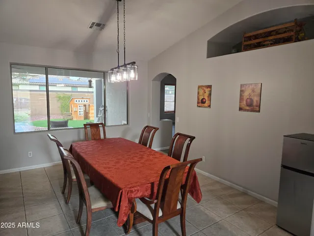 a view of a dining room with furniture window and outside view
