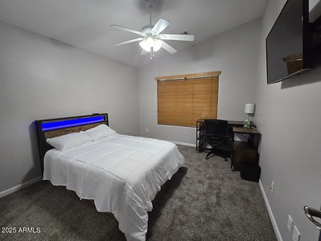 a bed room with a bed and a television