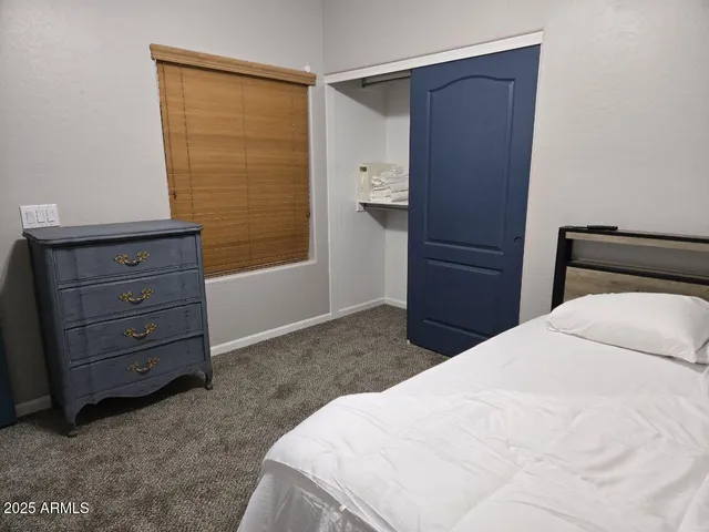 a bedroom with a bed and a dresser