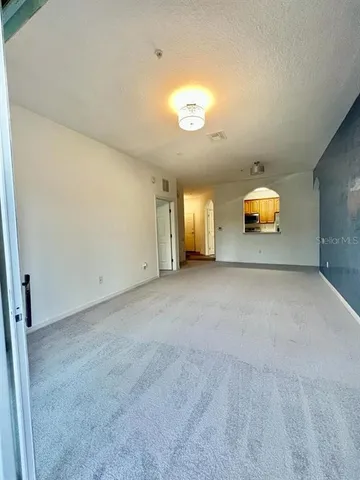 an empty room with a window and mirror