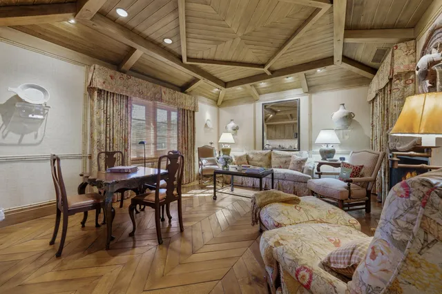 a living room with furniture a flat screen tv and a large window