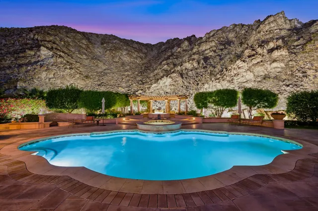 an aerial view of a house with a mountain