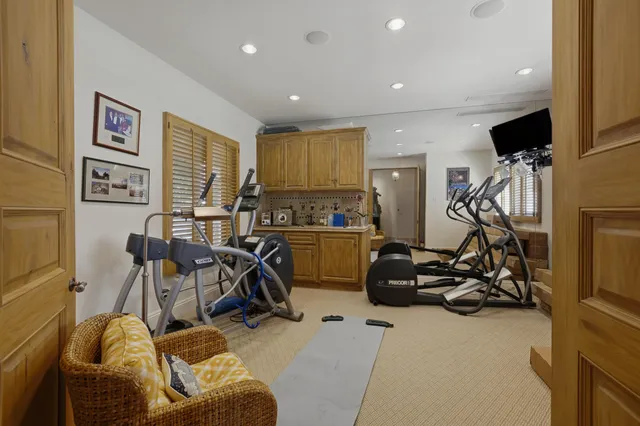 a living room with lots of furniture and a chandelier