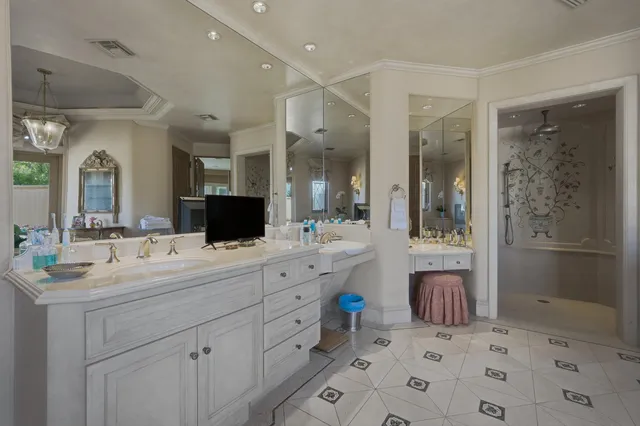 a front view of a house with a yard and potted plants