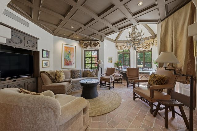 a front view of a building with a garden and plants