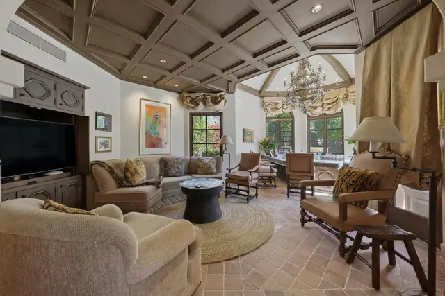 a front view of a building with a garden and plants