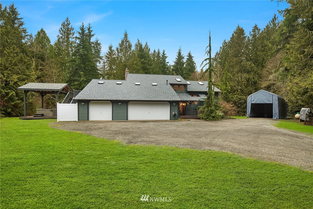 820 Carlson Road Snohomish, WA 98290 - Photo 1 of 39 a front view of a house with a yard and trees
