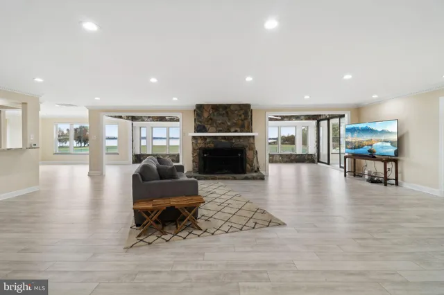 a view of a big room with wooden floor and a kitchen