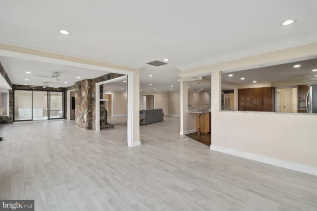 a large kitchen with stainless steel appliances kitchen island granite countertop wooden cabinets a sink and a granite counter tops