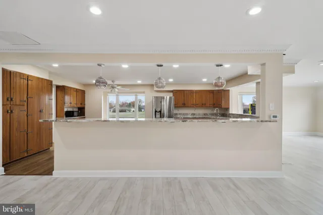 a view of a big room with wooden floor and windows