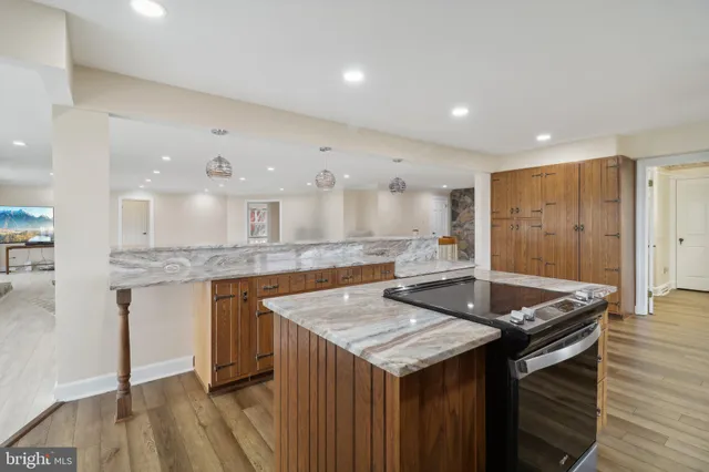 a view of a room with wooden floor and a table