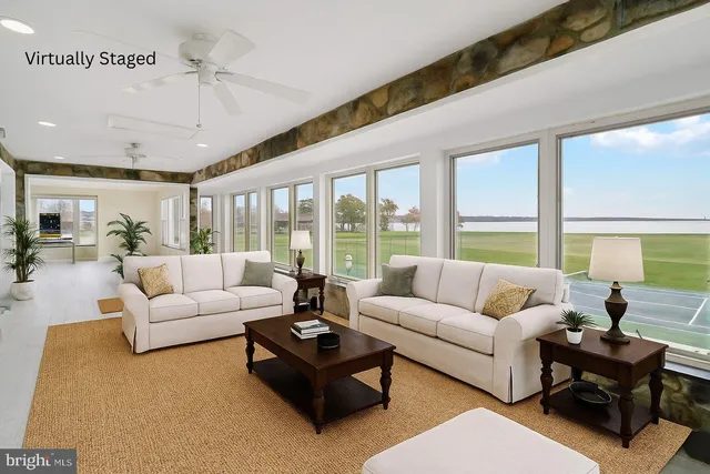 a view of a deck with furniture and a garden