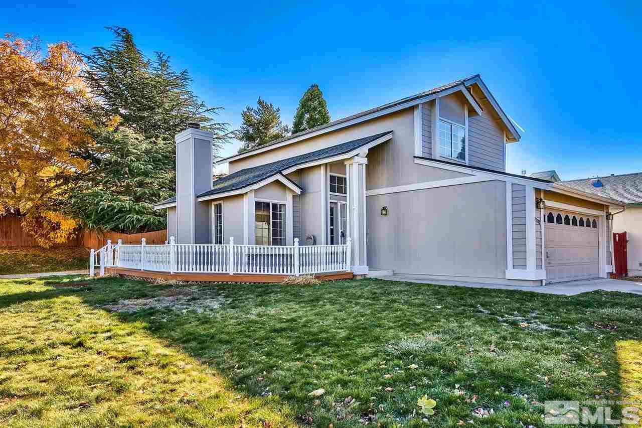 2702 Caballo Drive Reno, NV 89502 - Photo 2 of 17 a front view of a house with a yard and garage