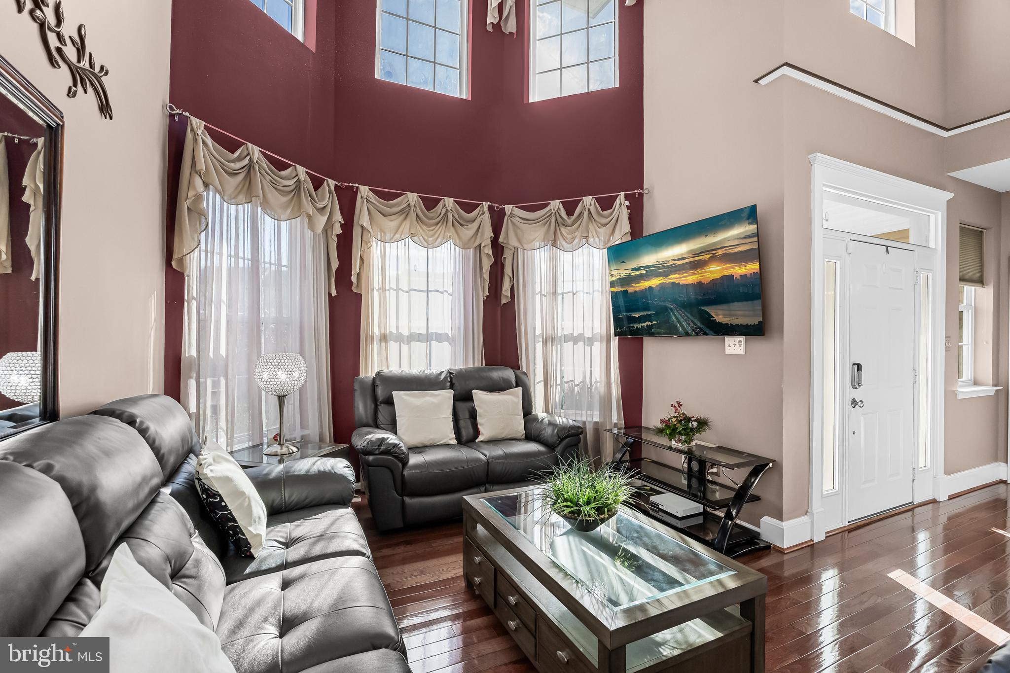 7 Manchester Court Wenonah, NJ 08090 - Photo 14 of 37 a living room with furniture a flat screen tv and a large window