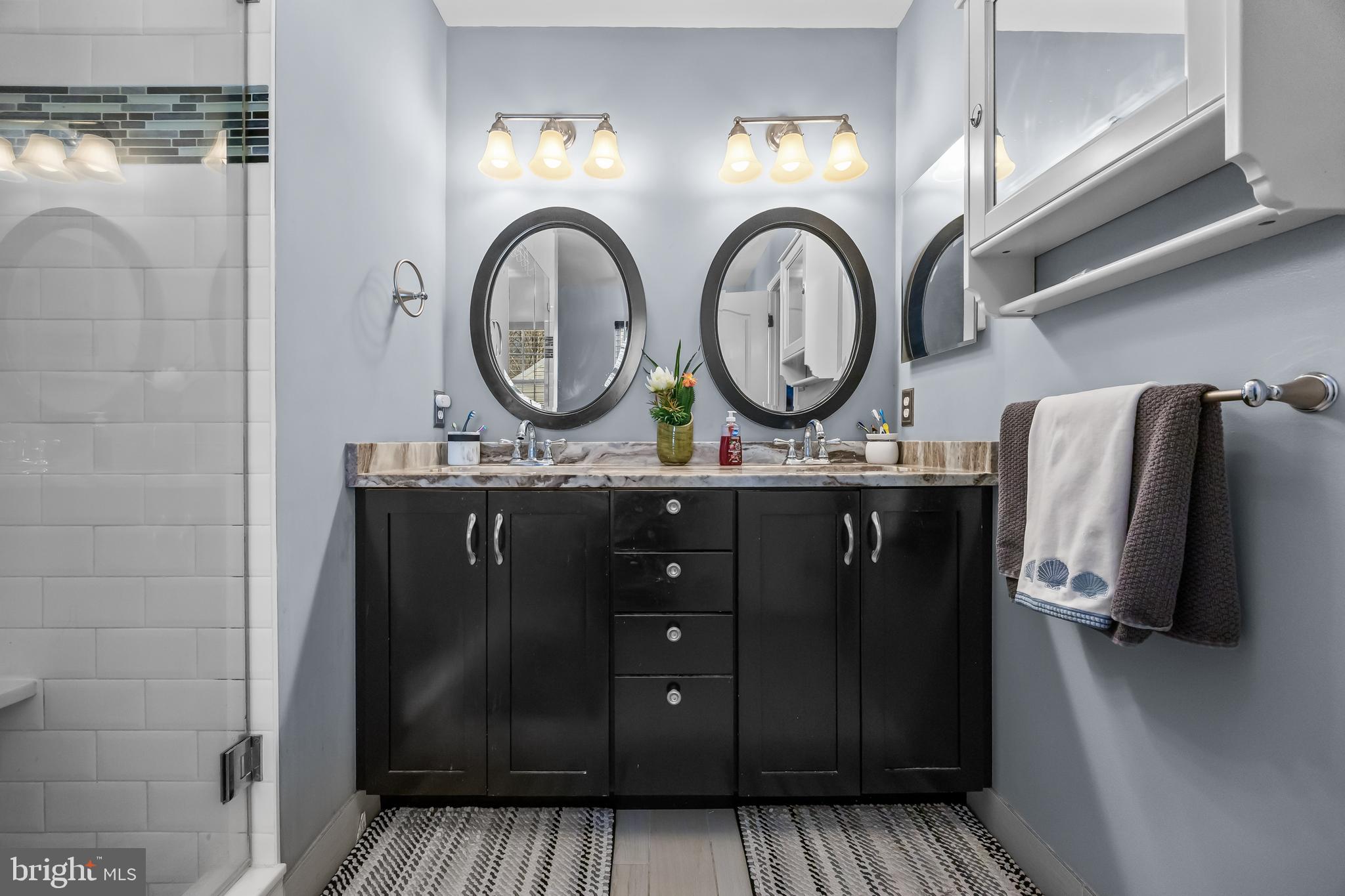 7 Manchester Court Wenonah, NJ 08090 - Photo 22 of 37 a bathroom with a sink a mirror and cabinets