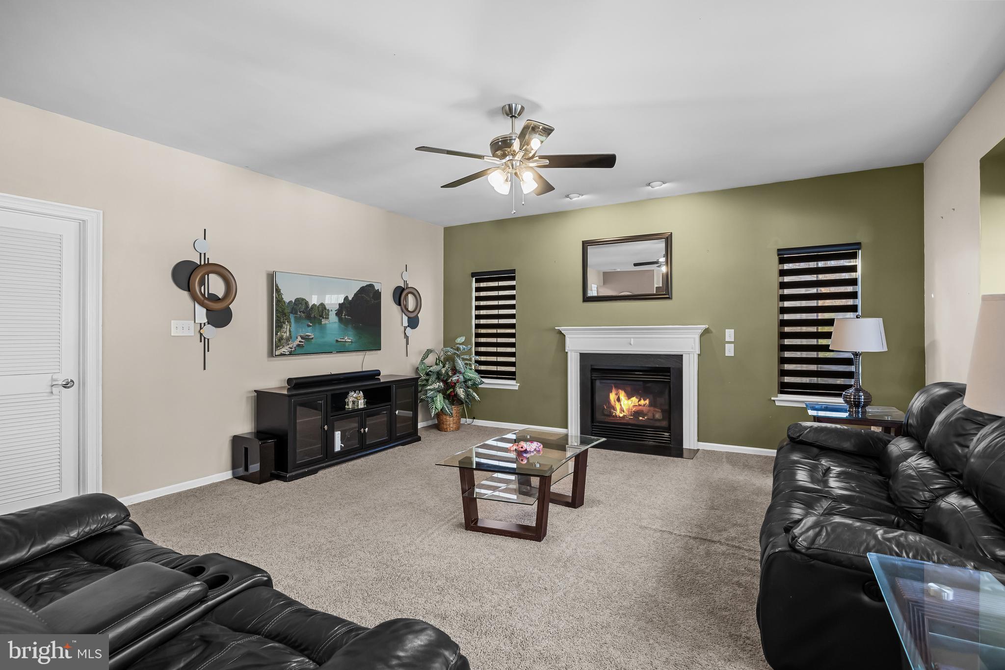 7 Manchester Court Wenonah, NJ 08090 - Photo 9 of 37 a living room with furniture a fireplace and a flat screen tv