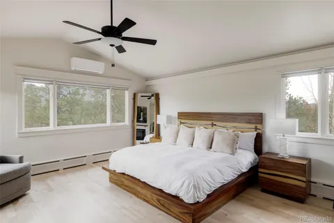 a bedroom with a bed a window and flowerpot