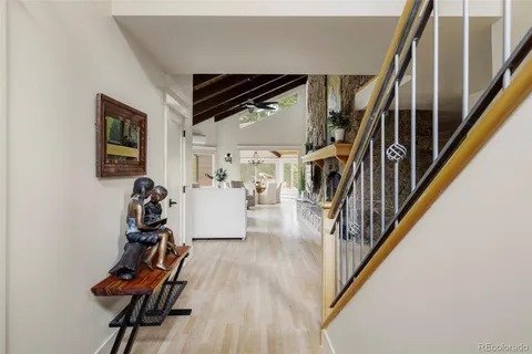 a view of a livingroom with wooden floor and stairs